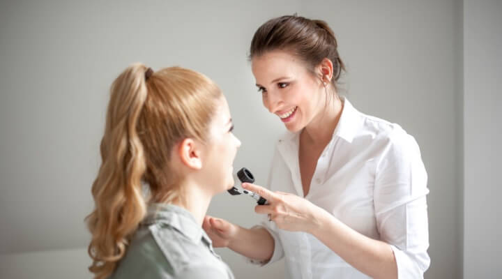 dermatologist inspecting mole