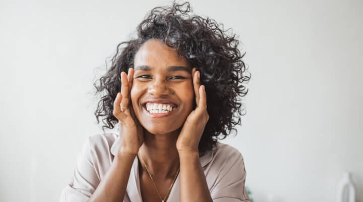 confident woman touching face