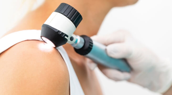 dermatologist inspecting back